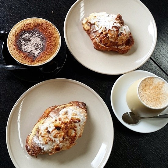 Simply Beans Boutique Coffee Roasters Pic 1 - Almond croissants accompanied with a coffee and a chai latte