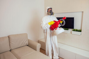 AYM Pest Control Pic 5 - Pest control worker in uniform spraying pesticides