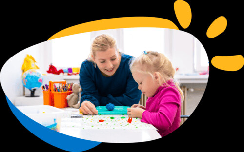 Functional Capacity Assessment Pic 1 - A young occupational therapist supporting a child in a creative activity representing Kid Senses Functional Capacity Assessment services for NDIS support and therapy