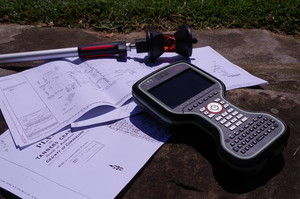 Advance Land Surveyors Pic 2 - CS20 Controller and 360 Degree Prism weighing down survey plans on site