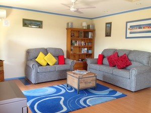 Bells By The Beach Holiday House Pic 5 - Comfortable living area wide screen TV cosy sofas dining area