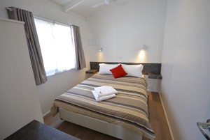 Rivergardens Holiday Park Pic 4 - Executive Riverview Cabin Main Bedroom