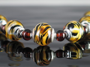 Mason Glassworks Pic 4 - handmade glass bead bracelet encased tiger design