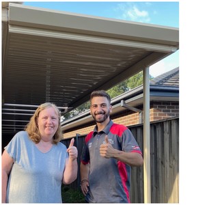 Melbournes Best Verandas Pic 2 - Our happy plumbing apprentice Michael with our even happier customer in front of her new flat veranda designed and installed by Melbournes Best Verandas