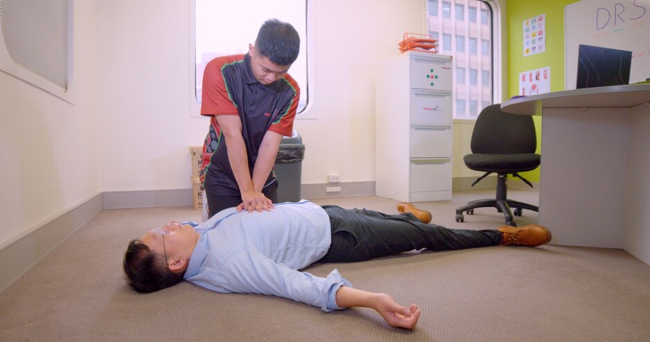 FirstAidPro - Parramatta Pic 1 - Performing Cpr on a patient in an office First Aid Training Course FirstAidPro