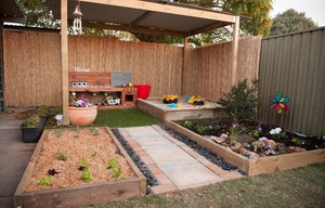 Garden Adventures Family Day Care Pic 2 - Our veggie garden on the left and dinosaur garden on the right