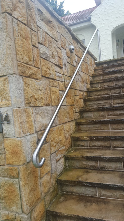 Elite Landscapes NSW Pty Ltd Pic 1 - Handcut and split sandstone cladding and steps Custom made stainless steel handrail installed