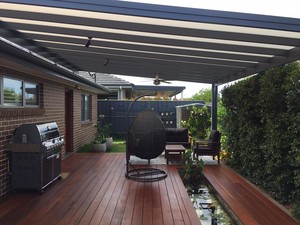 JGC Constructions Pty Ltd Pic 4 - Hardwood decking with an aluminium framed multiwall polycarbonate roof pergola Creating a tranquil outdoor living space with the inclusion of a recessed fish pond