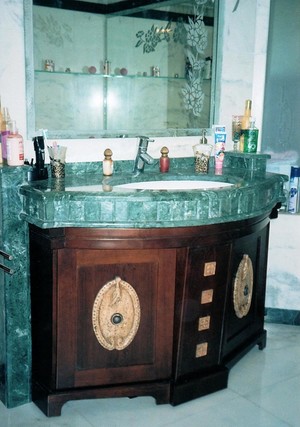 Emerald Custom Joinery Pic 3 - Cherry wood vanity with carved stone ornaments and granite surround