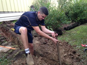 Barry's Electrical Contracting Pic 5 - Mason trenching for a power supply to a shed in Enoggera