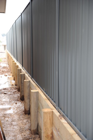 T. Foster & Sons PTY LTD Pic 4 - Retaining Wall in Treated Pine with Slate Grey Colorbond Fencing