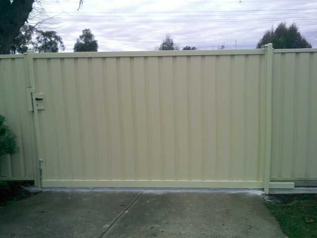 RELIABLE FENCING Pic 1 - colorbond sliding gate with keyed lock and matching post caps