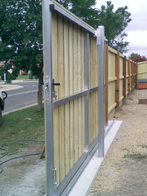 RELIABLE FENCING Pic 5 - rear view of capped timber sliding gate with galvanized steel frame and posts