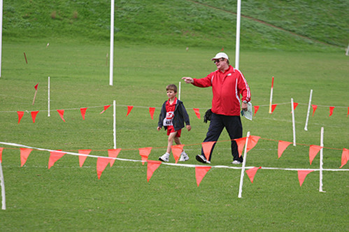 Adelaide Eagles Little Athletics Centre Pic 1 - Adelaide Eagles Little Athletics coach Norm Charles shows an under six runner around the cross country track before a race