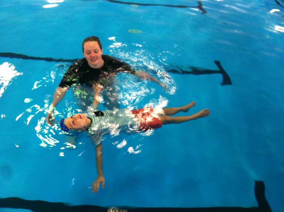 Swimworld Gold Coast Pic 1 - Aston is swimming in our Water Safety Week in his clothes and has learned to roll onto his back if he falls in and then roll back onto his tummy to kick and paddle back to the side