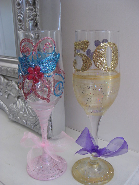 Prinses Personalised glassware Pic 2 - Flute glasses one with butterfly design and flower gems The other a more sophisticated gold purple 50th Birthday glass