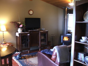 Lisnagarvey Cottage B&b Pic 5 - Cosy Lounge with Flatscreen TV wood fire and comfy leather lounge