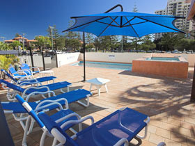 Barbados Holiday Apartments Pic 1 - Barbados Holiday Apartments Deck Chairs in Pool Area