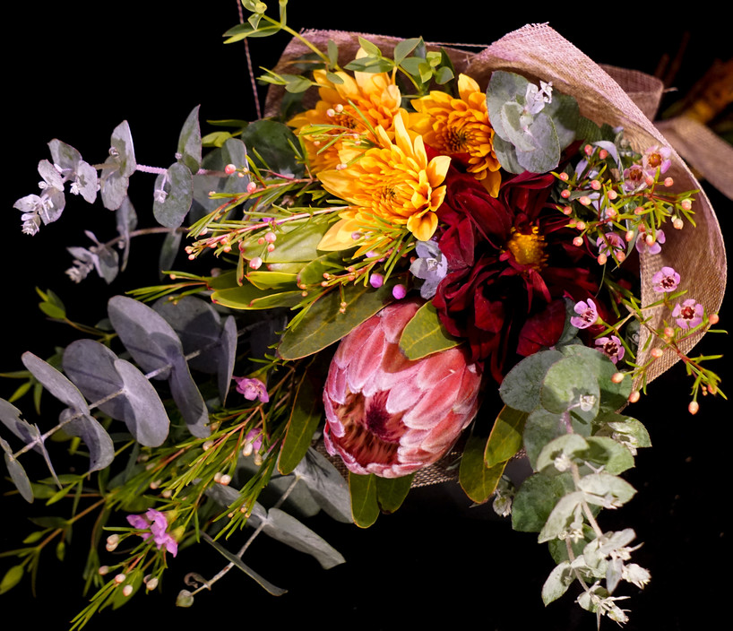 Raw Stem Pic 1 - Native Posy This petite Posy is the perfect gift for him or her a mixture of native foilage and seasonal florals to compliment in warm colours Finished with a lovely jute wrap and ribbon