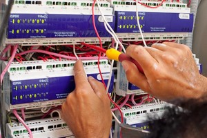 Ultratech Electrical Pic 2 - Ultratech working on a switchboard and Clipsal CBus system