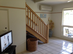 Coral Beach Noosa Resort Pic 2 - Lounge area stairs to bedrooms bathroom