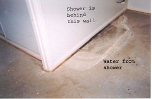 AAA Shower Seal Pic 2 - water stain to concrete on other side of wall to leaking shower