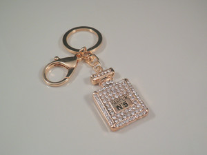 Little Treasure Box Pic 3 - This gorgeous key finder features a crystal studded perfume bottle in gold tone that is sure to delight any girl