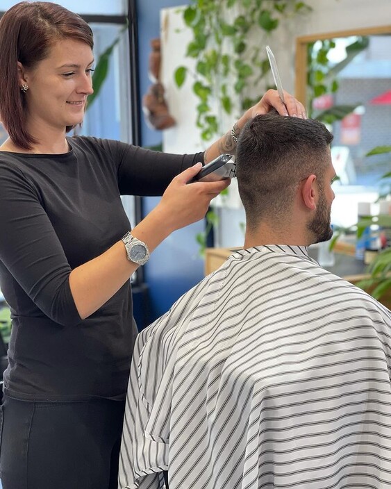 The Conductor Barbershop Pic 1 - Image of Barber giving a haircut to a client