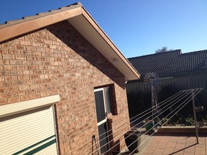 ACT Gutter Service Pic 3 - Before gable with painted wooden fascia