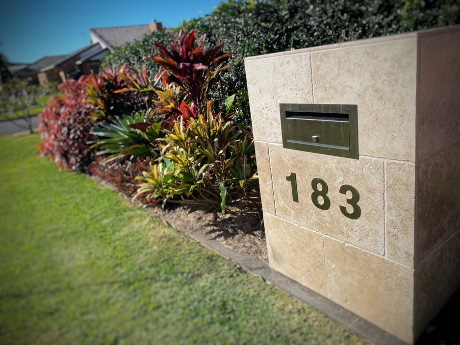 Original Oasis Pic 1 - Custom build travertine letterbox with a coulourful tropical garden