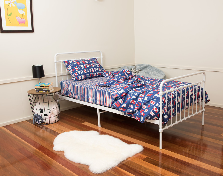 Gummybabies.com.au Pic 1 - The fantastic looking Akuna Metal Bed in white with Brolga Single Mattress and Flags fitted sheet and quilt cover