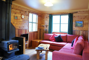 Cradle Mountain Highlanders Cottages Pic 2 - Forest View Two Bedroom lounge with a cosy log fire