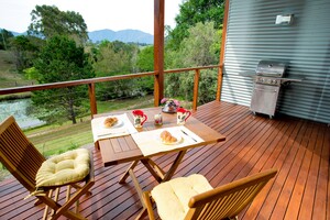 Lilypad Luxury Cabins Pic 5 - Private balcony complete with hooded BBQ and views across the lilypond to the mountains