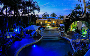 Toscana Village Resort Pic 5 - Evening lights around the pool and BBQ area Toscana Resort Airlie Beach