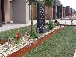 Exseed Landscaping Pic 3 - Merbau planter box Water feature Turf Pebbles