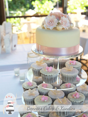 Bonnie's Cakes & Kandies Pic 4 - Rainbow Beach wedding cake Cutting cake and cupcake tower with handmade butterflies piped roses icing roses and pearls