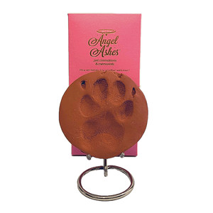 Angel Ashes Pet Cremations Pic 5 - Clay Paw Impressions are a great way to memorialize your pet The diameter of the clay circle is approximately 10cms Comes packaged in a beautiful Angel Ashes pink and white keepsake box and a custom made nickel plated brass display stand