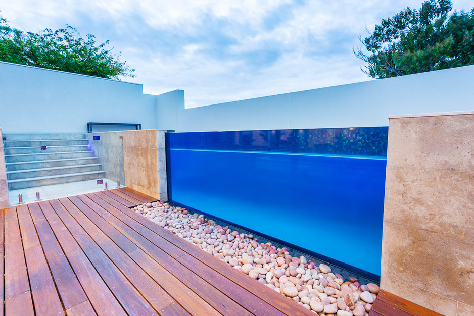 Boardwalk Pools Pic 1 - Stunning Above Ground Concrete Swimming Pool in Cottesloe with massive glass window infinity vanashing edge overflow area