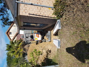 Trevs Excavations Pic 3 - 2 tonne excavator walking up ramps from backyard after level backyard for pathways footings and concrete slab