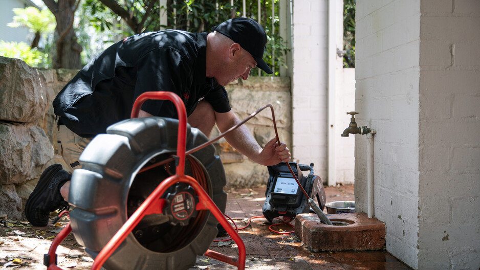 Anytime Drains Pic 1 - Mark Lawler Master plumber and owner Anytime Drains conducting a high tech CCTV Drain Camera Inspection of a blocked sewer at a Sydney home