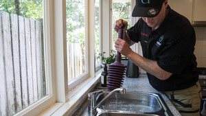 Anytime Drains Pic 4 - Mark Lawler Master plumber and owner Anytime Drains onsite in Sydney fixing blocked kitchen drain