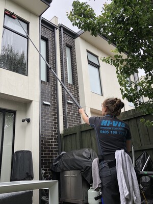 Hi Vis Window Cleaning Pic 3 - Cleaning high hard to reach windows with our water fed pole technology