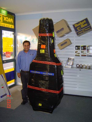 Pack & Send Pic 2 - store owner jamal with a double bass to be sent to usa