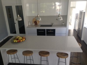 House of Carveth Pic 4 - Kitchen with marble look silestone benches and splashback waterfall end large island bench pendant lighting Miele appliances concealed bin silent powerful exhaustext motor