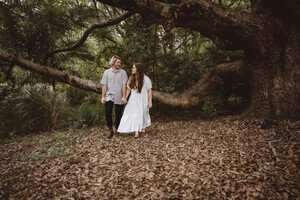 Joanna Kate Photography Pic 3 - Young couple holding hands and walking together in the forest during a photo shoot in Arana Hills Brisbane