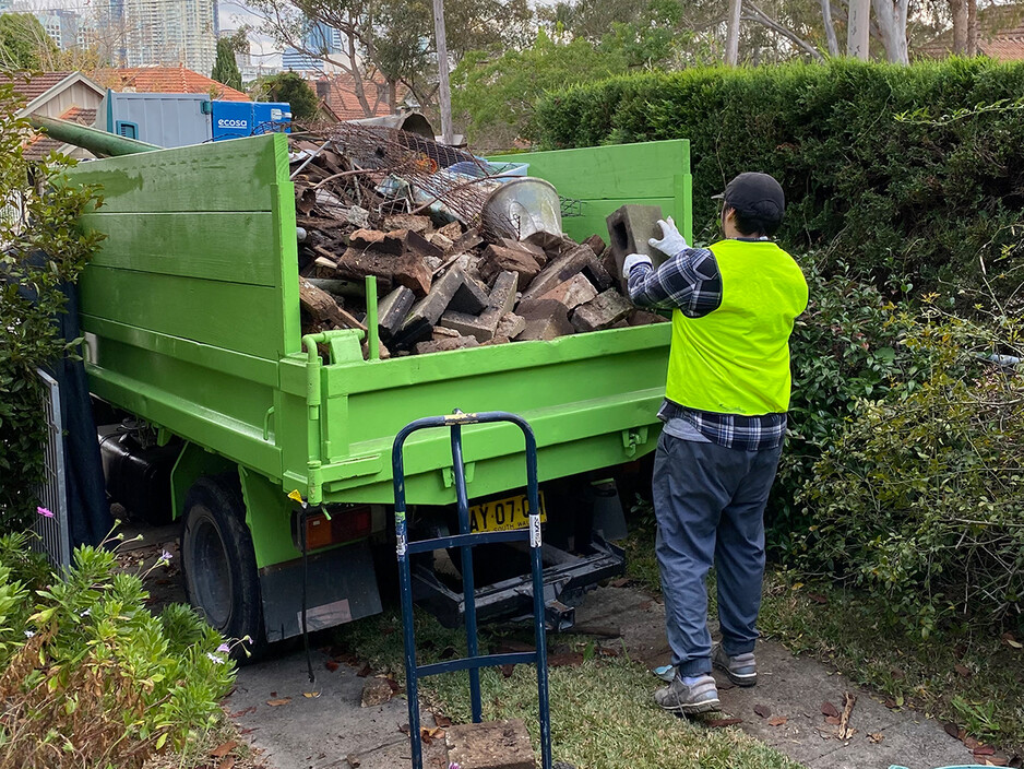 Rubbish Rocket Pic 1 - Team member loading waste truck with mixed rubbish including construction waste garden waste and furniture