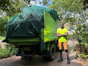 Rubbish Rocket Pic 3 - Rubbish Rocket team member stands proud next to a fully loaded and secured waste truck ready for disposal the green way