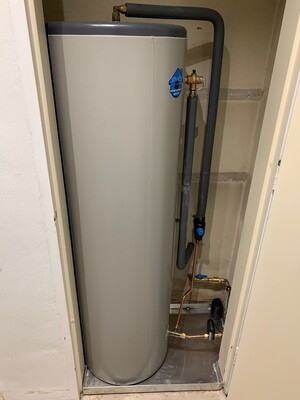 Straco Plumbing Solutions Pic 2 - Hot water system installed in cupboard with tray and leak detection automatic shut off valve