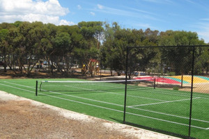 BIG4 Port Willunga Tourist Park Pic 2 - BIG4 Port Willunga Tourist Park tennis court and jumping pillow