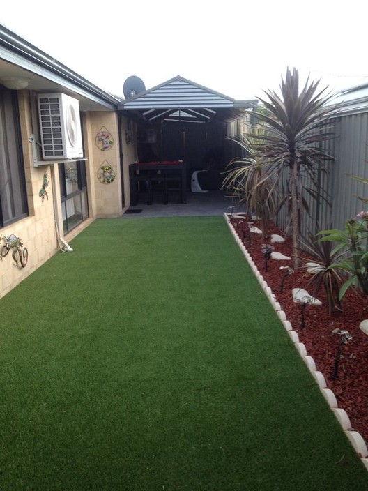 Dubys Landscaping Pic 1 - original grass ripped up and replaced with synthetic lawn plants and mulching also completed